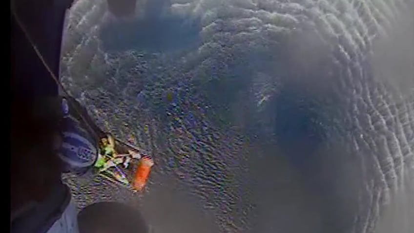 video shows us coast guards daring rescue of couple dog after florida boat takes on water