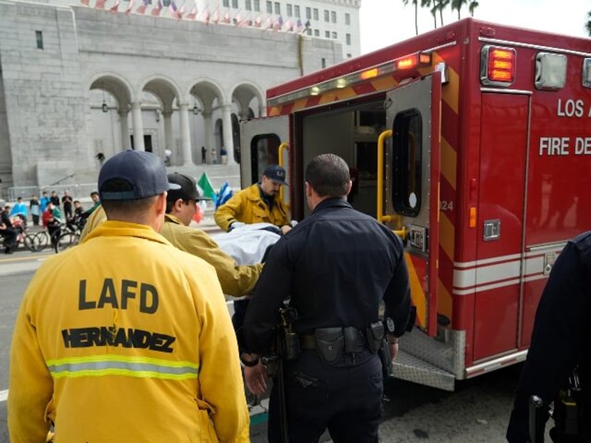 An unidentified high school student is taken into an ambulance by paramedics after a fist