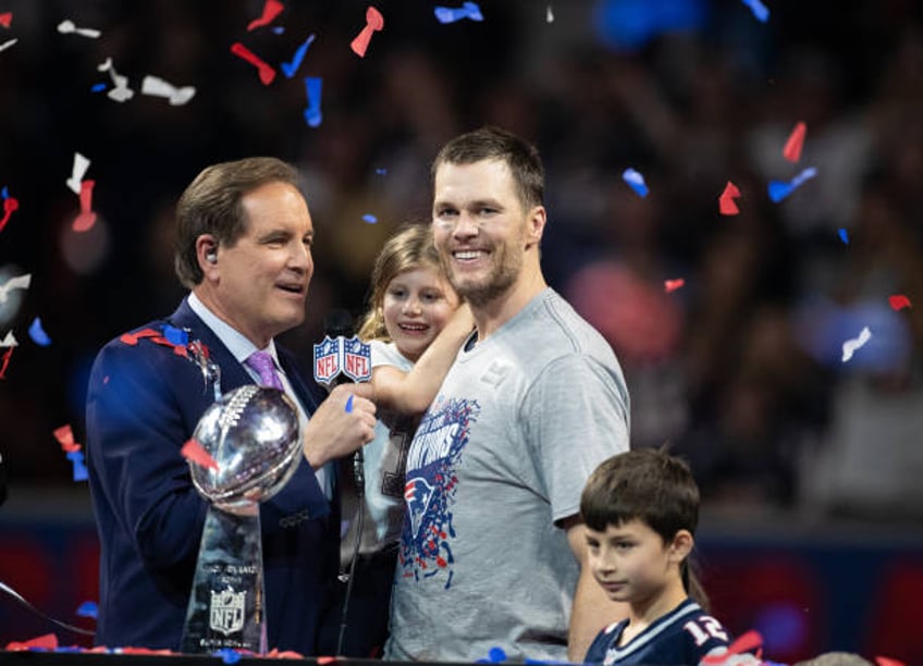 Tom Brady and his daughter Vivian Brady with Jim Nantz celebrating during the award ceremony for Super Bowl LIII at Mercedes-Benz Stadium on February...