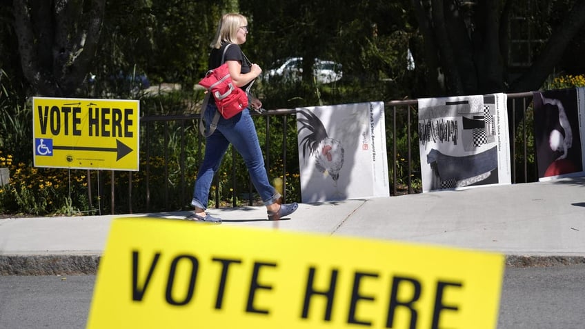 A person walks past polling station during Massachusetts state primary voting on Tuesday. 