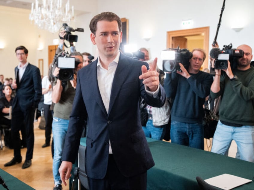 Photographers take pictures of Austria's former Chancellor Sebastian Kurz as he arrives at