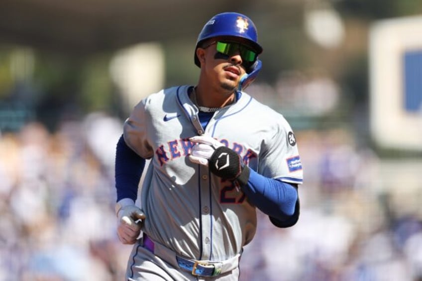 Mark Vientos of the New York Mets runs the bases after hitting a grand slam home run in a