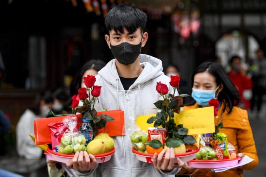 Young Vietnamese flock to an ancient pagoda in Hanoi hoping a Valentine's Day offering wil