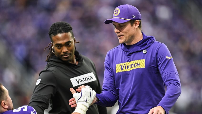 Kevin O'Connell greets player on sideline