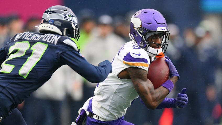 Jordan Addison carries the ball