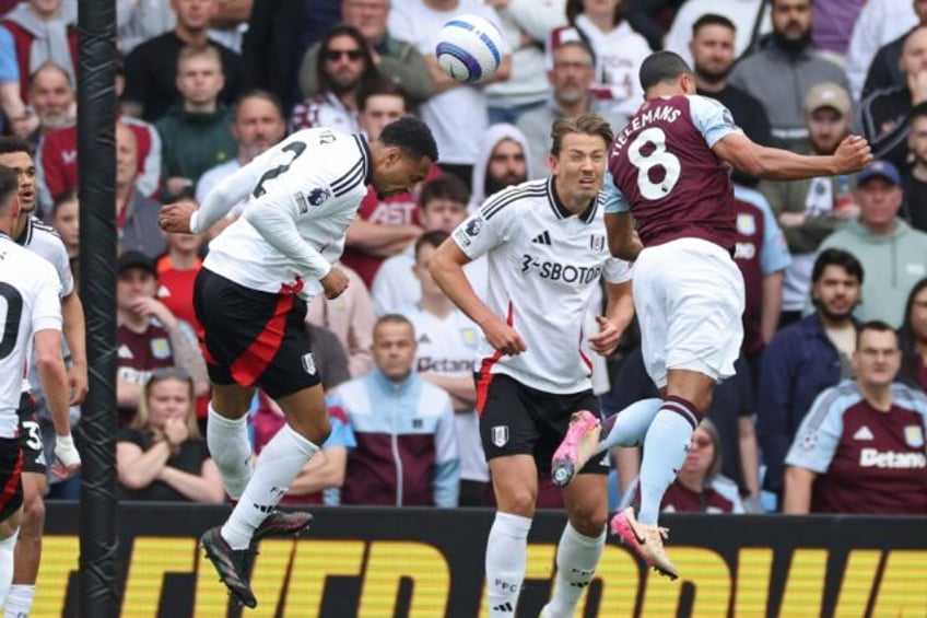 Aston Villa's Youri Tielemans (R) heads the winner against Fulham