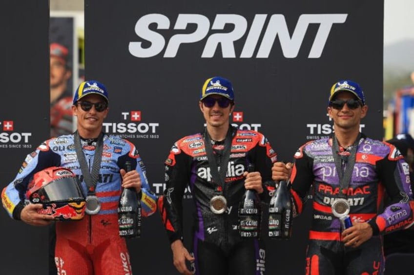 Top three: Maverick Vinales (C) poses with second-placed Marc Marquez and Jorge Martin af