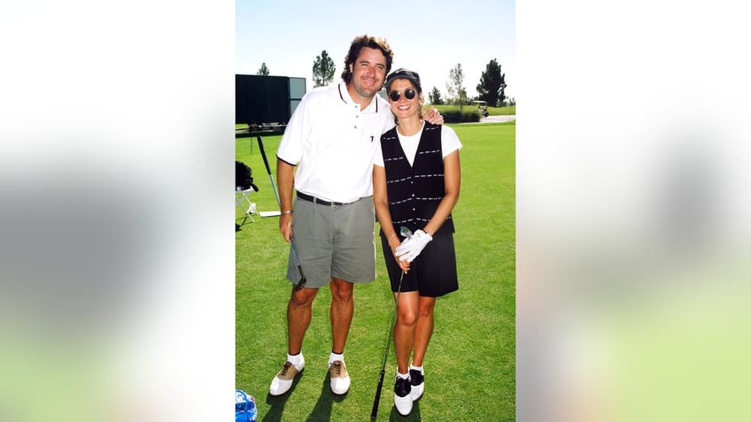 vince gill and amy grant pose together on a golf course in 1996