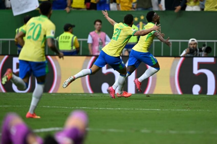 Brazil's Vinicius Jr (R) celebrates after scoring the winner against Colombia in World Cup