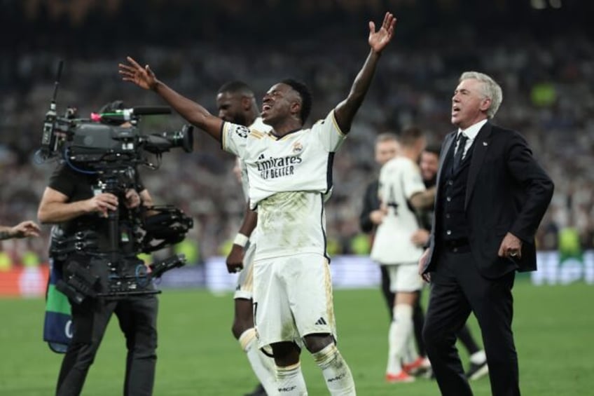 Carlo Ancelotti (R) and Vinicius celebrate reaching the Champions League final last season