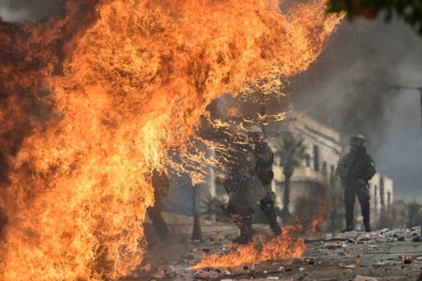 Riot police clashed with some protesters who threw petrol bombs outside the Greek parliame