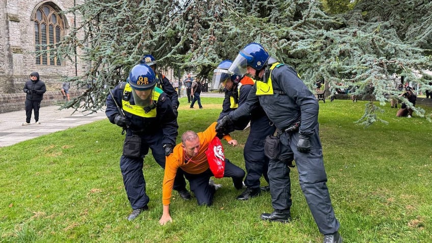 Man being arrested during UK protests