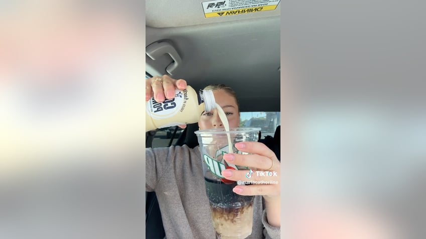 Marla pouring protein drink in soda