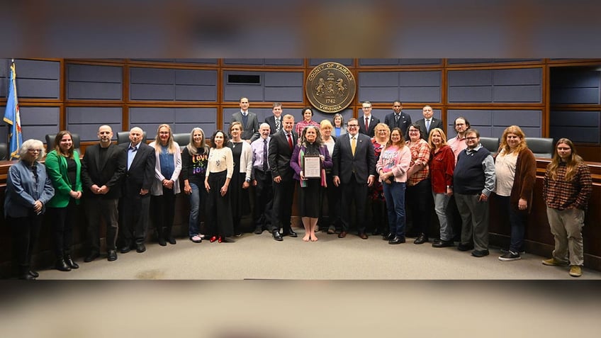 Virginia county legislators pose with a proclamation.