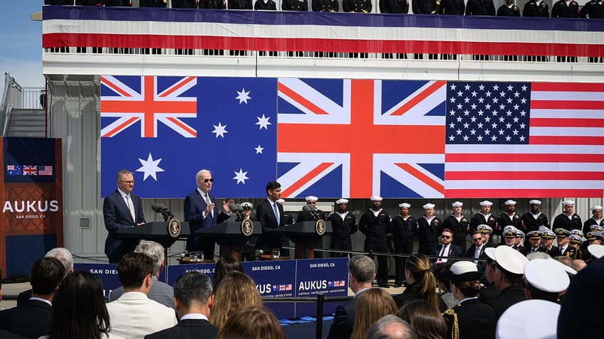 The three flags of the US, UK, and Australia