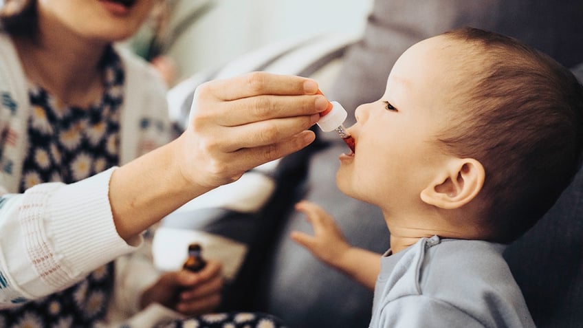 baby given liquid drops in mouth