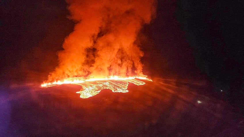 Billowing smoke and flowing lava are seen in this Icelandic Department of Civil Protection and Emergency Management , January 14, 2024, handout image during an volcanic eruption on the outskirts of the evacuated town of Grindavik, western Iceland. Seismic activity had intensified overnight and residents of Grindavik were evacuated, Icelandic public broadcaster RUV reported. This is Iceland's fifth volcanic eruption in two years, the previous one occurring on December 18, 2023 in the same region southwest of the capital Reykjavik. Iceland is home to 33 active volcano systems, the highest number in Europe. (Photo by Icelandic Department of Civil Protection and Emergency Management / AFP) (Photo by ICELANDIC DEPARTMENT OF CIVIL PROTECTION AND EMERGENCY MANAGEMENT/AFP via Getty Images)