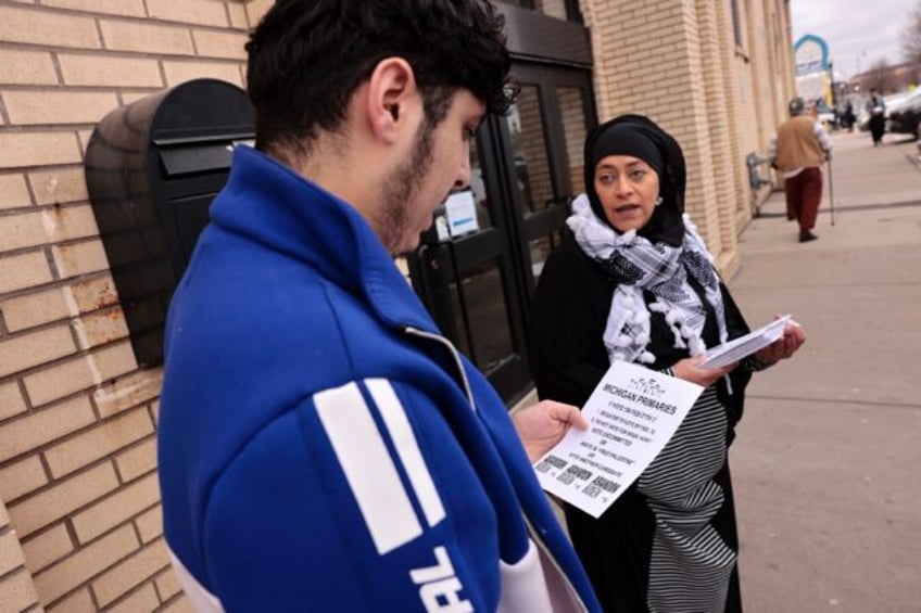 Samra'a Luqman hands out fliers outside the American Moslem Society Mosque