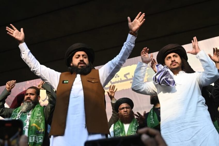 Saad Rizvi (left) gestures to supporters during a protest in Lahore on Saturday