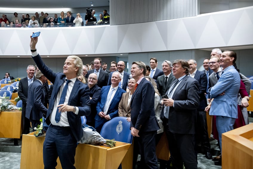 PVV Party leader Geert Wilders (L) takes a selfie during the swearing-in of the House of Representatives as parliament sits for the first time after the recent election, in The Hague, on December 6, 2023. Despite a stunning election win, the far-right politician faces an uphill battle to forge a coalition with other parties, uncomfortable with his anti-Islamic views, as he seeks a four-way coalition with the centre-right VVD, the current ruling party, the pro-reform New Social Contract and the BBB farmers party. (Photo by Koen van Weel / ANP / AFP) / Netherlands OUT (Photo by KOEN VAN WEEL/ANP/AFP via Getty Images)