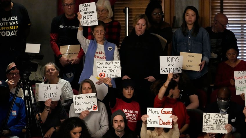 Protesters raise signs in Tennessee House chamber in Nashville