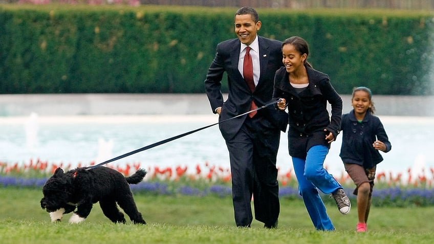 Malia and Sasha Obama with dog