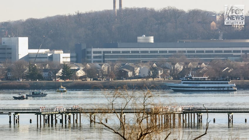 Emergency response units respond to the crash site of an American Airlines plane and Black Hawk helicopter on the Potomac River