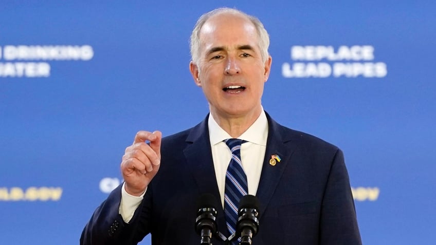 Sen. Bob Casey gesturing with right hand at podium