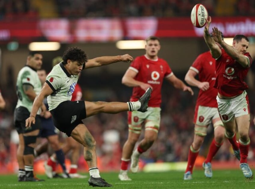 Fiji's fly-half Caleb Muntz has his kick charged down