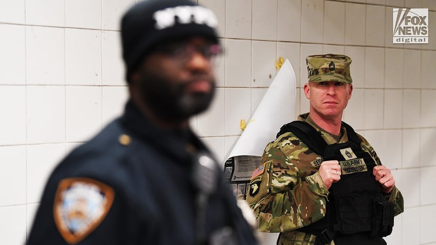 Members of the NYPD and National Guard conduct randomized bag searches in New York City’s subway system