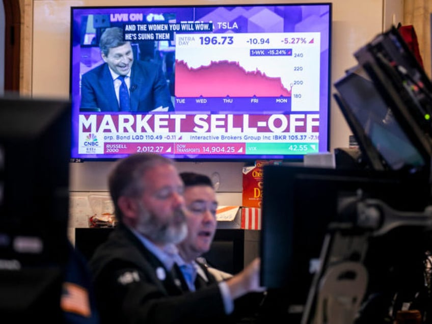 A television displays stock market news on the floor of the New York Stock Exchange (NYSE)