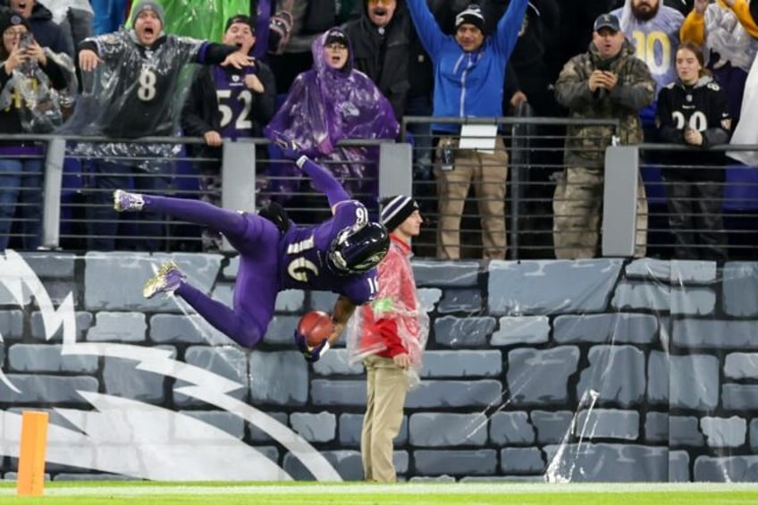 Tylan Wallace leaps into the end zone to cap his 76-yard game-winning touchdown punt return in Baltimore's 37-31 win over the Los Angeles Rams