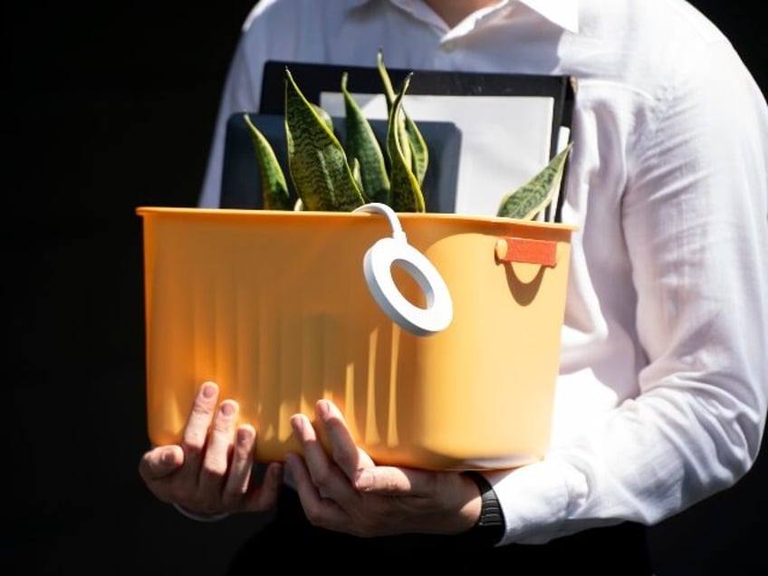 a laid off worker carrying his possessions