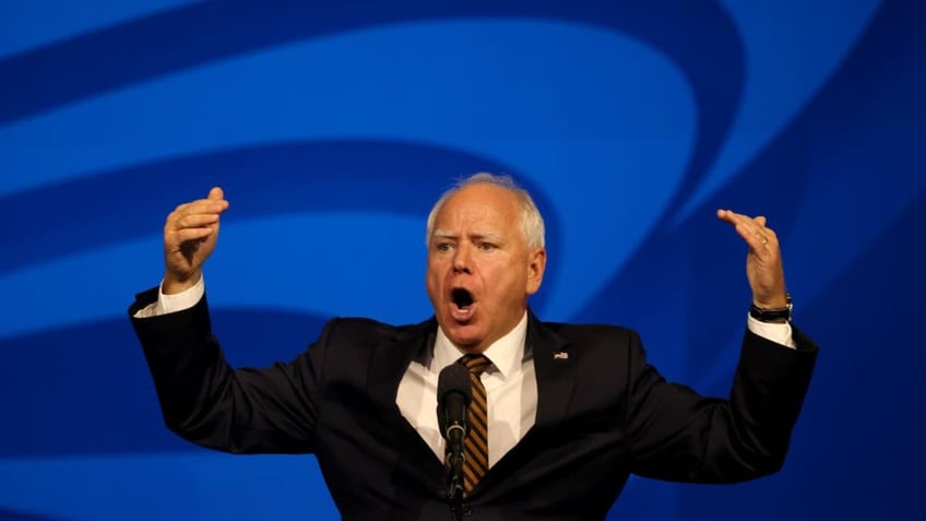 Tim Walz with arms raised