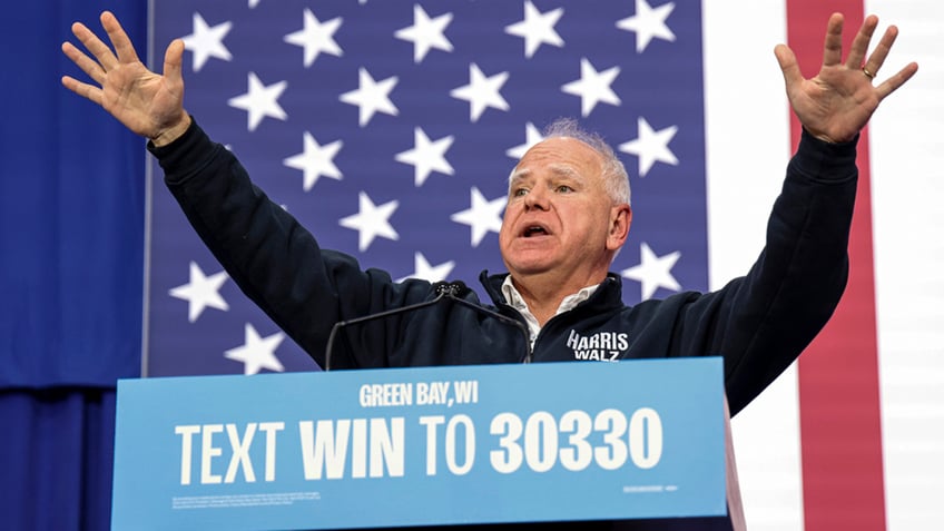 Tim Walz with his hands in the air