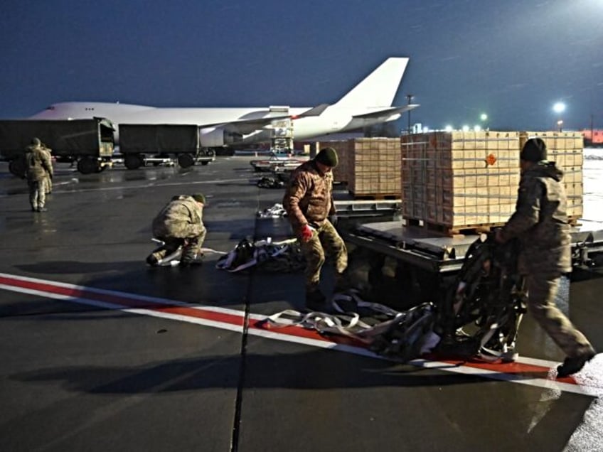 Employees unload a plane carrying US military aid at Kyiv's Boryspil airport on February 5