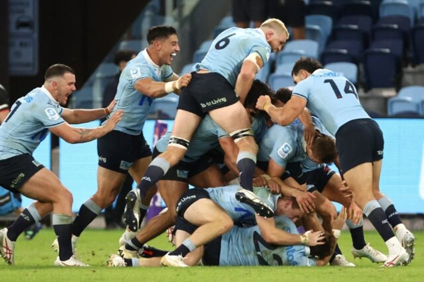 Waratahs’ players celebrate teammate the Crusaders in Sydney