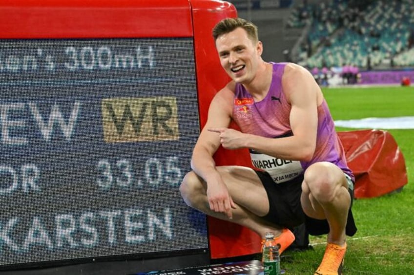 Norway's Karsten Warholm poses with his time of 33.05 seconds after he broke the men's 300
