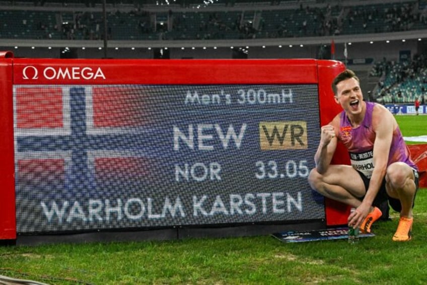 Norway's Karsten Warholm poses with his time of 33.05 seconds after he set a new best in t