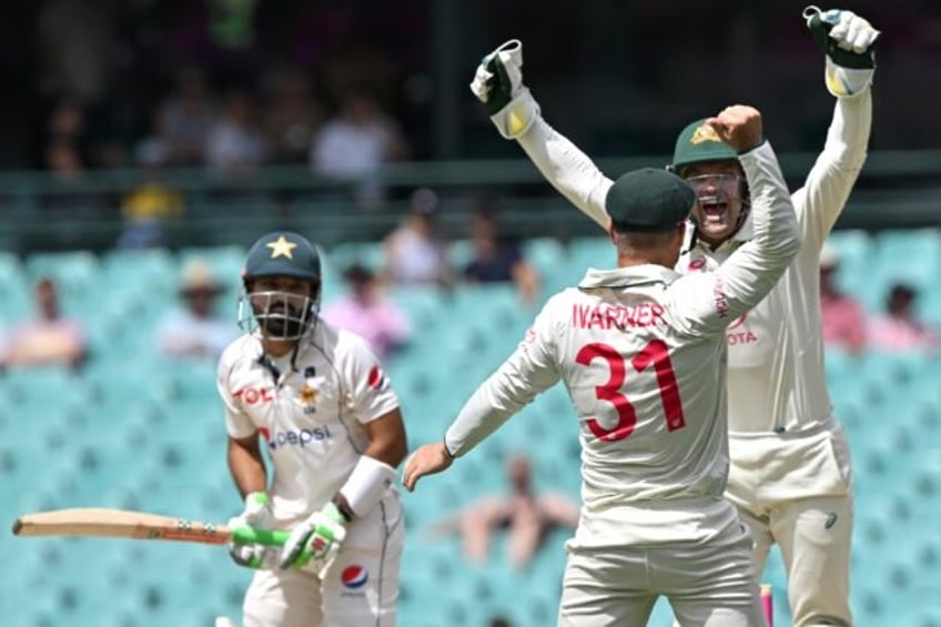 Australia’s David Warner takes a successful catch in the third Test