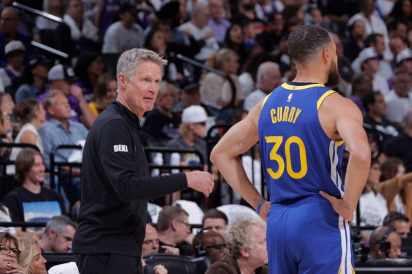 Head Coach Steve Kerr of the Golden State Warriors coaches Stephen Curry during the game against the Sacramento Kings during the 2024 Play-In...