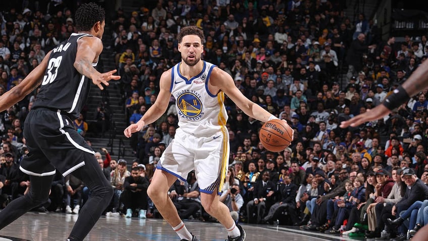 Klay Thompson dribbles during a game