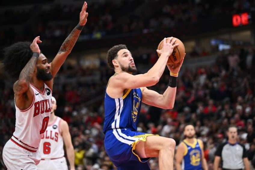 Golden State's Klay Thompson drives to the basket past Coby White in the Warriors' NBA victory over the Chicago Bulls