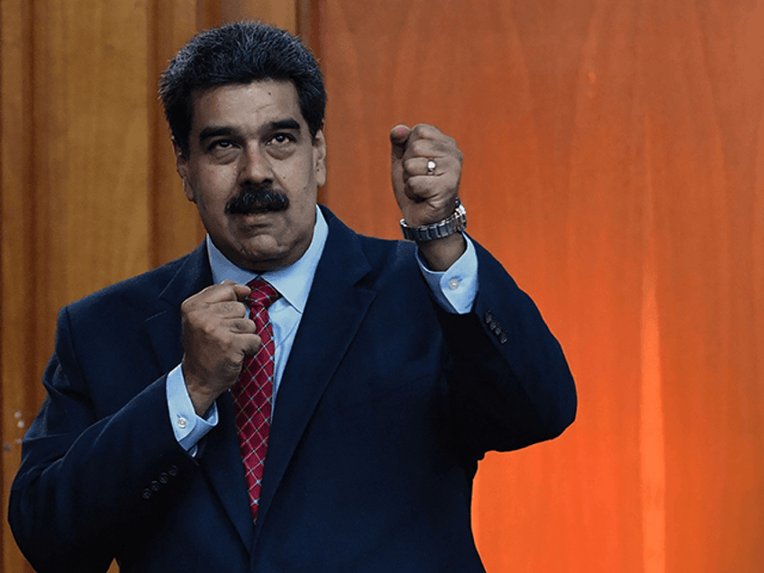 Venezuelan President Nicolas Maduro leaves after offering a press conference in Caracas, on January 25, 2019. - Venezuela's opposition leader Juan Guaido called Friday for a "major demonstration" next week to demand the resignation of President Nicolas Maduro, in his first public appearance since declaring himself "acting president" two days ago. (Photo by Yuri CORTEZ / AFP) (Photo credit should read YURI CORTEZ/AFP via Getty Images)