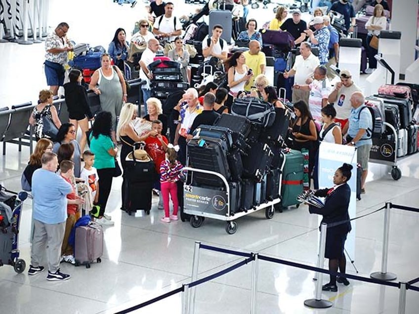 Passengers wait in line at Terminal 1 in John F. Kennedy International Airport one day aft