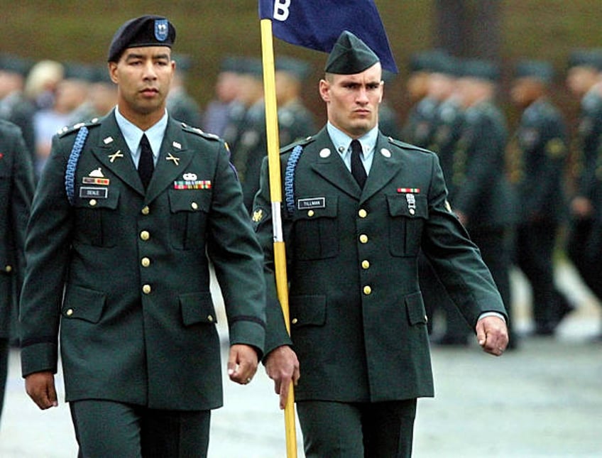 Specialist Pat Tillman, right, a former Arizona Cardinal, walks next to Captain Christoper Deale, company commander of B Company 1st BN 19th Infantry...