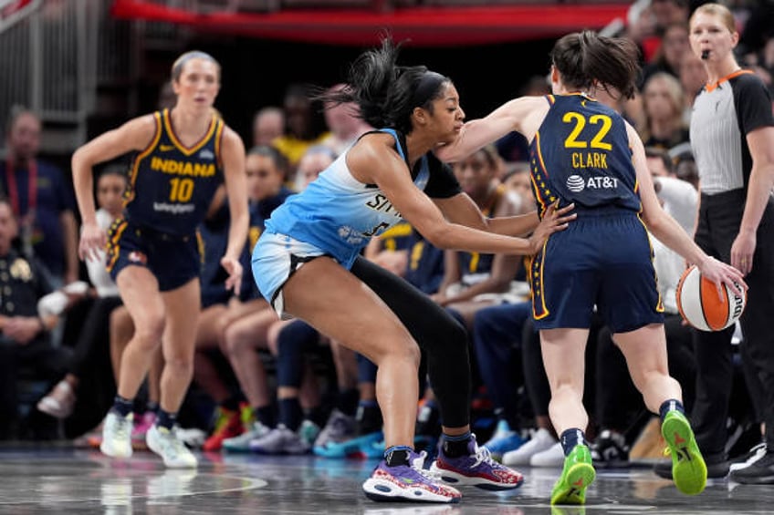 Angel Reese of the Chicago Sky fouls Caitlin Clark of the Indiana Fever during the second half at Gainbridge Fieldhouse on June 16, 2024 in...