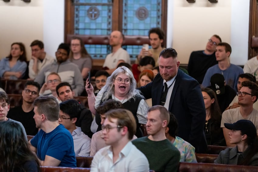 CAMBRIDGE, CAMBRIDGESHIRE - MAY 08: A protestor inside The Cambridge Union as Peter Thiel speaks at The Cambridge Union on May 08, 2024 in Cambridge, Cambridgeshire. (Photo by Nordin Catic/Getty Images for The Cambridge Union)