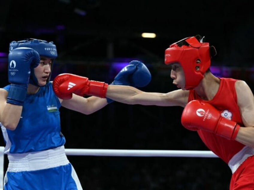 Taiwan's Lin Yu-ting (in red) fights against Uzbekistan's Sitora Turdibekova in