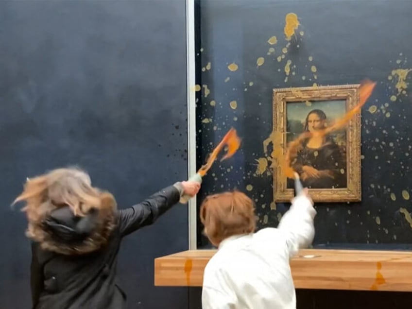 TOPSHOT - This image grab taken from AFPTV footage shows two environmental activists from the collective dubbed "Riposte Alimentaire" (Food Retaliation) hurling soup at Leonardo Da Vinci's "Mona Lisa" (La Joconde) painting, at the Louvre museum in Paris, on January 28, 2024. Two protesters on January 38, 2024 hurled soup …